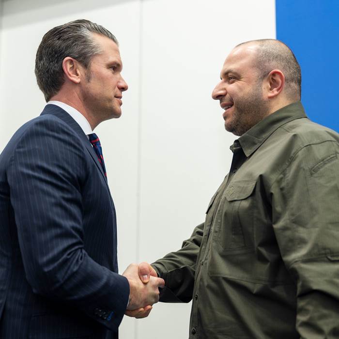 Pete Hegseth in a blue pinstripe suit, Rustem Umerov in green military dress.