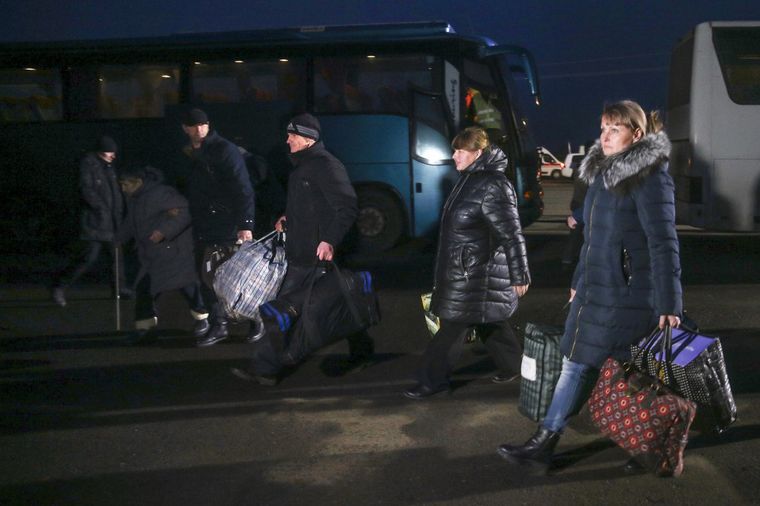 Марина Чуйкова (праворуч) та інші звільнені з полону самопроголошеної «ДНР» прямують з автобусів до тимчасових наметів на КПВВ «Майорське», Донецька область, 29 грудня 2019 року